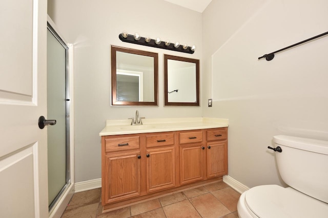 full bath with toilet, vanity, baseboards, tile patterned floors, and a shower with shower door