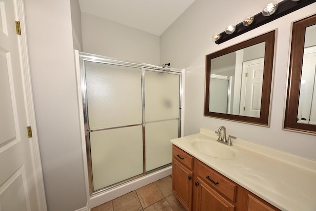 full bathroom with a shower stall, vanity, and tile patterned flooring