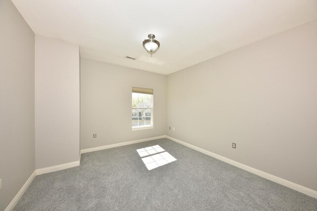 spare room with carpet floors and baseboards