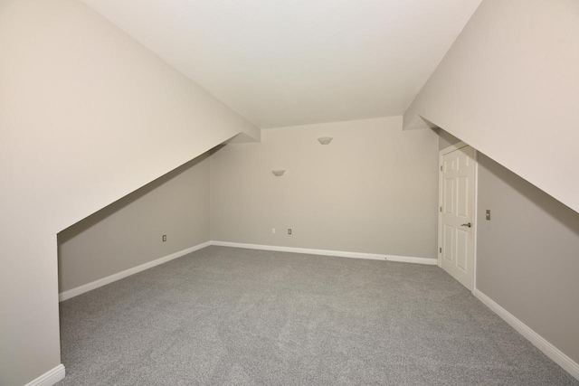 bonus room featuring carpet floors, baseboards, and lofted ceiling