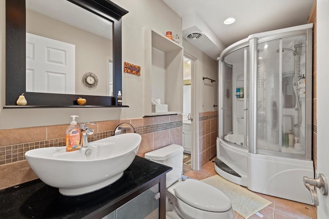 N6120 Evergreen Dr, Elkhorn, WI 53121 - bathroom featuring a stall shower, tile walls, tile patterned flooring, vanity, and toilet