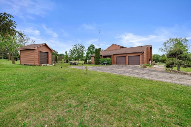 N6120 Evergreen Dr, Elkhorn, WI 53121 - view of grassy yard with a garage, a storage unit, an outbuilding, and driveway