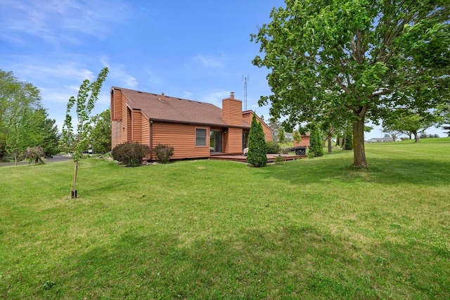 N6120 Evergreen Dr, Elkhorn, WI 53121 - rear view of property featuring a chimney and a lawn