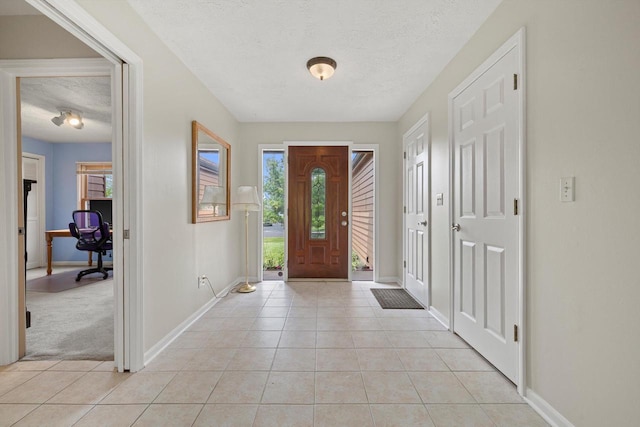N6120 Evergreen Dr, Elkhorn, WI 53121 - entryway featuring light tile patterned flooring, baseboards, and a textured ceiling