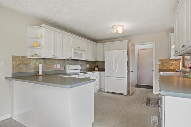 N6120 Evergreen Dr, Elkhorn, WI 53121 - kitchen featuring white appliances, a peninsula, open shelves, tasteful backsplash, and a textured ceiling