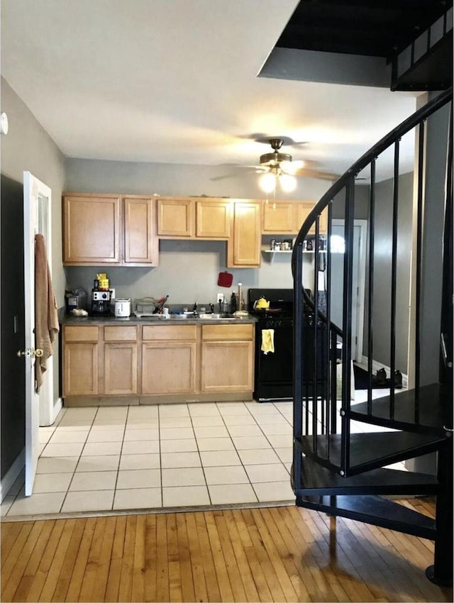 812 E Clarke St Unit 814, Milwaukee, WI 53212 - kitchen with stove, dark countertops, a ceiling fan, and light brown cabinets