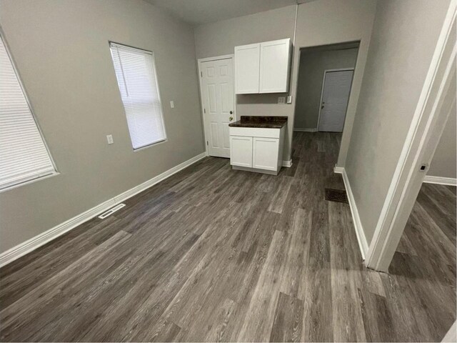 812 E Clarke St Unit 814, Milwaukee, WI 53212 - unfurnished dining area with dark wood-type flooring and baseboards
