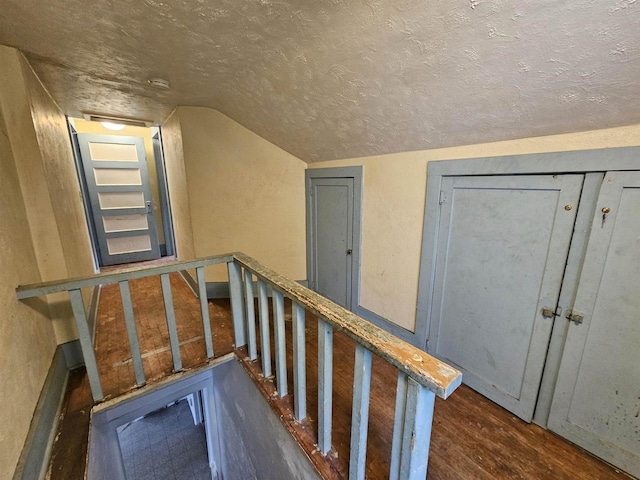 308 W Prospect St, Endeavor, WI 53930 - stairway with wood finished floors, vaulted ceiling, a textured ceiling, and baseboards