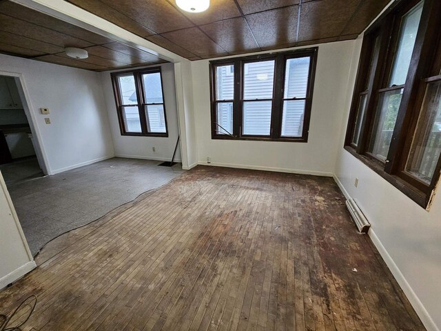 308 W Prospect St, Endeavor, WI 53930 - empty room with wood-type flooring, baseboards, and a baseboard heating unit