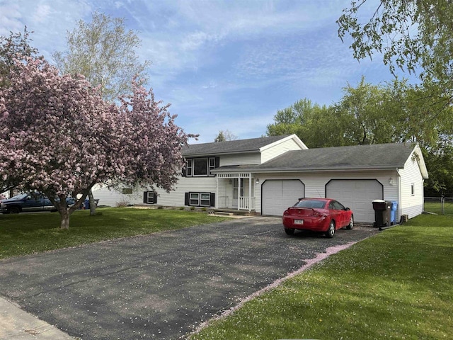 220-222 Lincoln St, Brooklyn, WI 53521 - tri-level home featuring a garage, a front lawn, and driveway