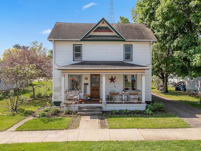 610 W Franklin St, Portage, WI 53901 - view of front of property featuring covered porch, a front yard, and a shingled roof