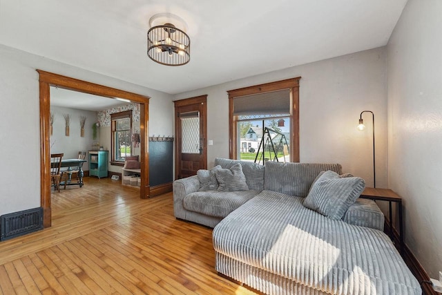 610 W Franklin St, Portage, WI 53901 - living area with a chandelier, light wood-style flooring, and baseboards