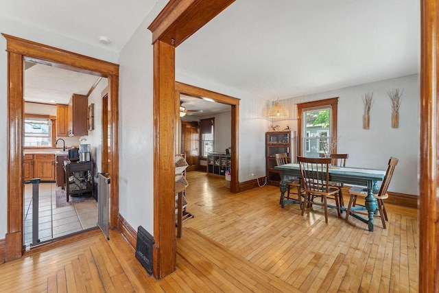 610 W Franklin St, Portage, WI 53901 - dining room featuring plenty of natural light, light wood-style flooring, radiator heating unit, and a ceiling fan