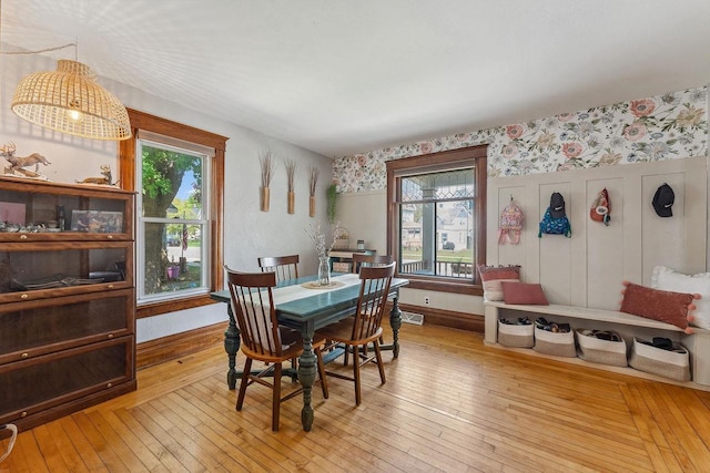 610 W Franklin St, Portage, WI 53901 - dining area featuring wallpapered walls, plenty of natural light, light wood-style flooring, and baseboards