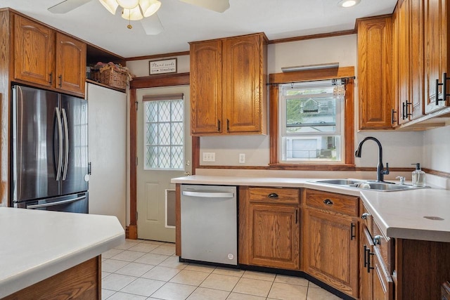 610 W Franklin St, Portage, WI 53901 - kitchen featuring appliances with stainless steel finishes, a sink, brown cabinets, ceiling fan, and light tile patterned floors