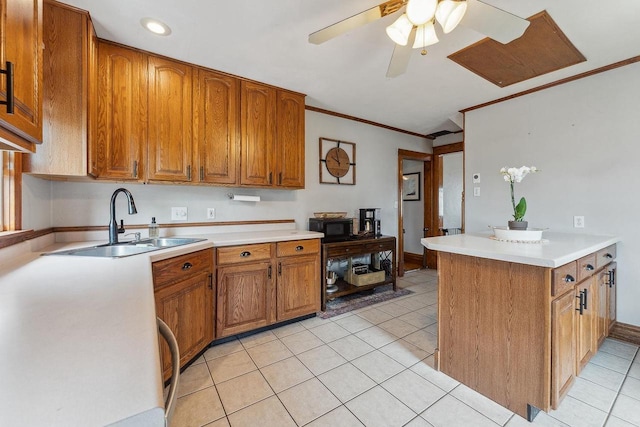 610 W Franklin St, Portage, WI 53901 - kitchen featuring a sink, black microwave, brown cabinets, ornamental molding, and light tile patterned floors