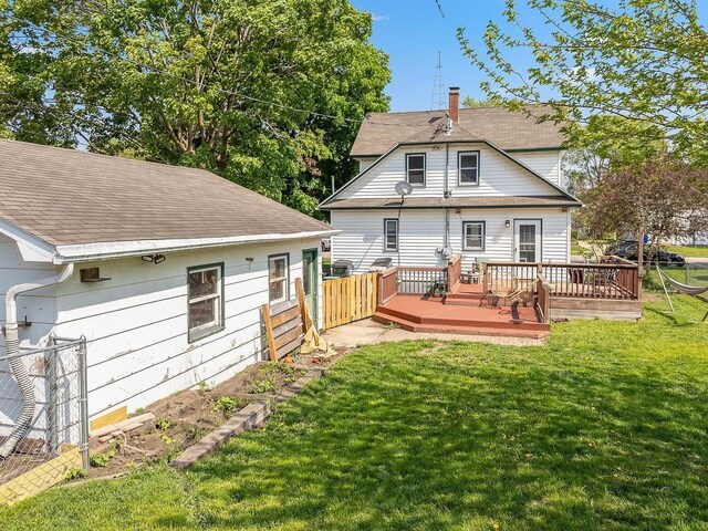 610 W Franklin St, Portage, WI 53901 - rear view of house featuring a deck, roof with shingles, and a chimney