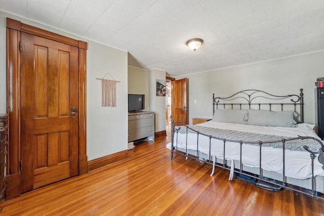 610 W Franklin St, Portage, WI 53901 - bedroom featuring wood finished floors, baseboards, and crown molding