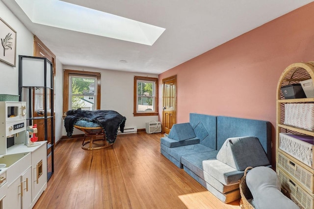 610 W Franklin St, Portage, WI 53901 - living area featuring a skylight, light wood-type flooring, baseboard heating, and baseboards