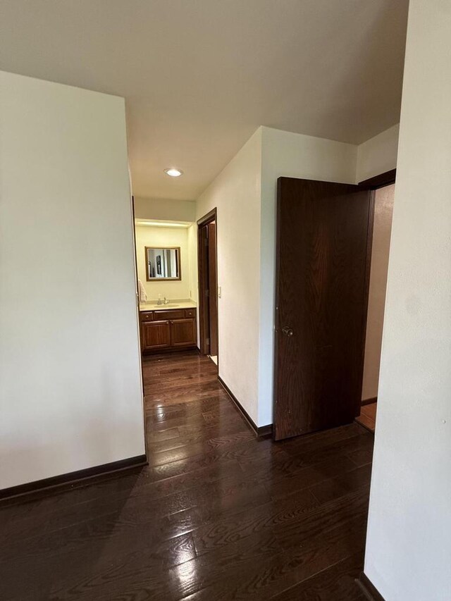 N1961 Hickory Ln, La Crosse, WI 54601 - hall featuring dark wood-type flooring, baseboards, and recessed lighting