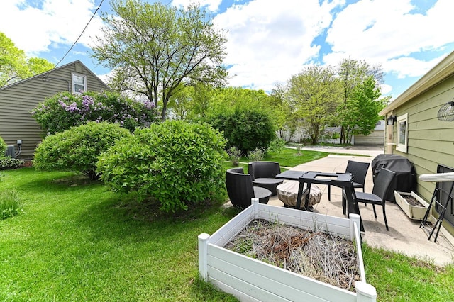 2377 S 73rd St, West Allis, WI 53219 - view of grassy yard featuring an outdoor living space, a patio, and a vegetable garden