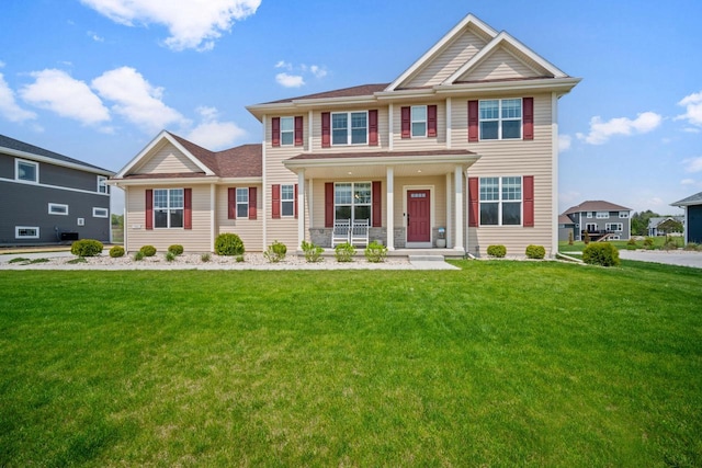 view of front of home featuring covered porch and a front yard
