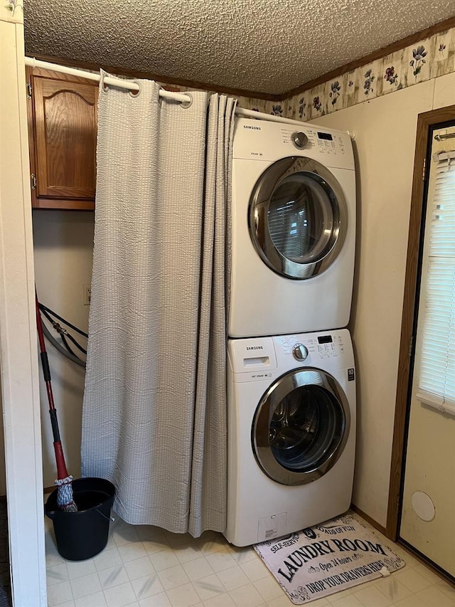 laundry room with stacked washer / dryer and a textured ceiling