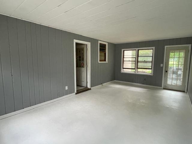 1546-15461/2 Garfield Ave, Beloit, WI 53511 - empty room with finished concrete floors and wooden walls