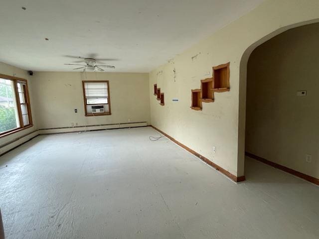 1546-15461/2 Garfield Ave, Beloit, WI 53511 - spare room featuring arched walkways, healthy amount of natural light, a ceiling fan, and baseboards