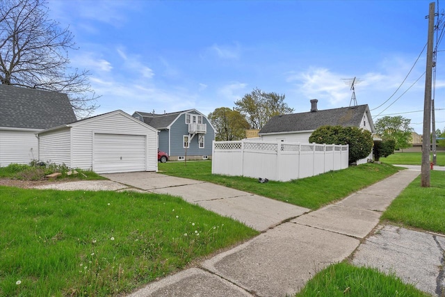 1143 S 23rd St, Manitowoc, WI 54220 - view of yard with concrete driveway and an outbuilding