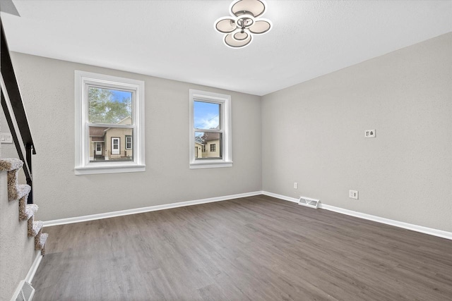 1143 S 23rd St, Manitowoc, WI 54220 - unfurnished room with dark wood-type flooring and baseboards