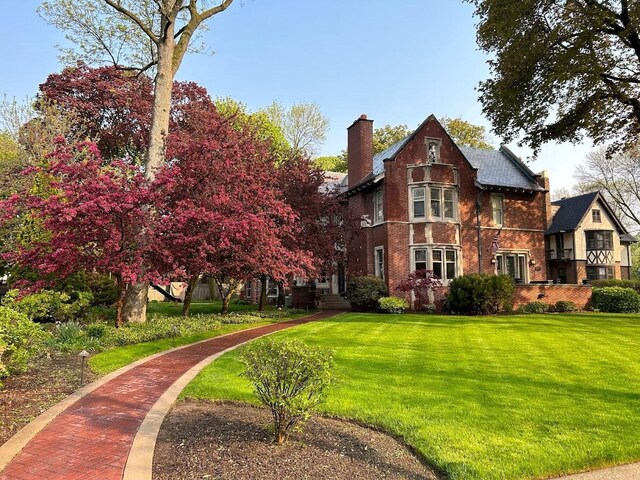 2663 N Wahl Ave, Milwaukee, WI 53211 - view of front facade with a front lawn, brick siding, and a chimney