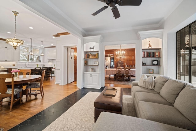 2663 N Wahl Ave, Milwaukee, WI 53211 - living area featuring built in features, ceiling fan, a chandelier, ornamental molding, and recessed lighting