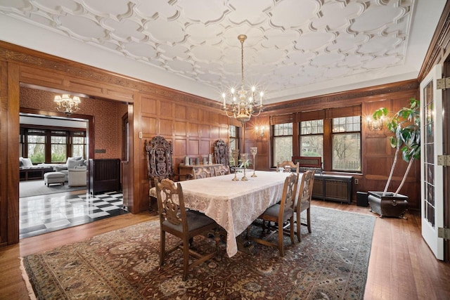 2663 N Wahl Ave, Milwaukee, WI 53211 - dining area featuring a chandelier, wood finished floors, wooden walls, and a tray ceiling