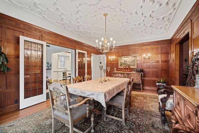 2663 N Wahl Ave, Milwaukee, WI 53211 - dining space with a chandelier, wood finished floors, and wooden walls
