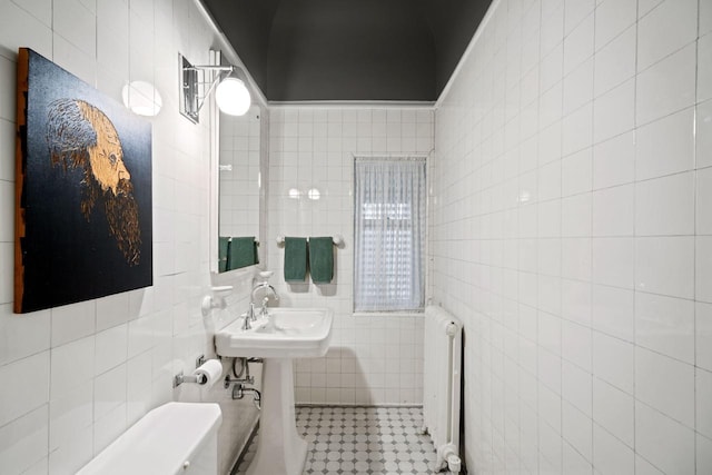 2663 N Wahl Ave, Milwaukee, WI 53211 - bathroom featuring radiator, tile walls, a sink, and tile patterned floors