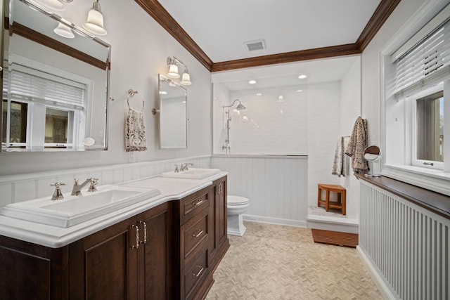2663 N Wahl Ave, Milwaukee, WI 53211 - full bath featuring double vanity, a tile shower, toilet, wainscoting, and crown molding