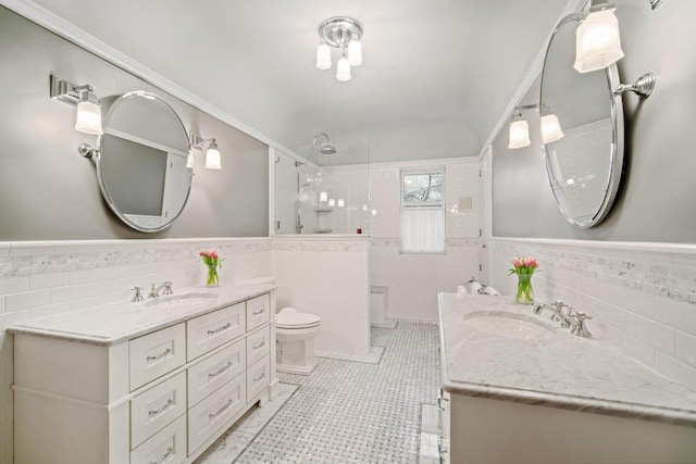 2663 N Wahl Ave, Milwaukee, WI 53211 - full bath featuring tile walls, a walk in shower, two vanities, a wainscoted wall, and toilet