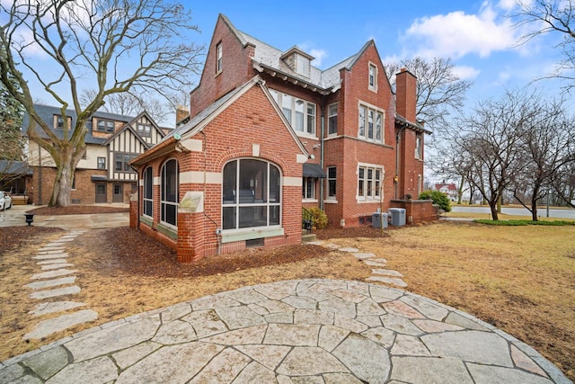 2663 N Wahl Ave, Milwaukee, WI 53211 - back of property with brick siding, central air condition unit, and a chimney