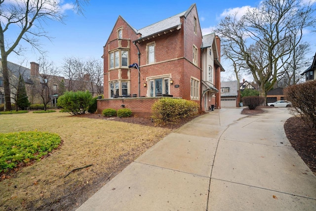 2663 N Wahl Ave, Milwaukee, WI 53211 - view of side of home with brick siding, a lawn, a garage, and driveway