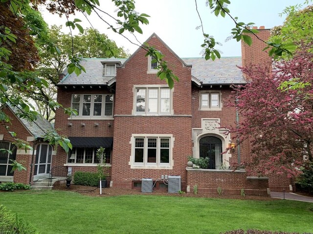 2663 N Wahl Ave, Milwaukee, WI 53211 - back of house featuring a lawn, brick siding, a high end roof, and cooling unit