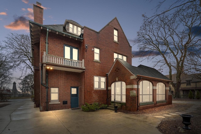 2663 N Wahl Ave, Milwaukee, WI 53211 - view of front of property with a chimney, brick siding, and a balcony