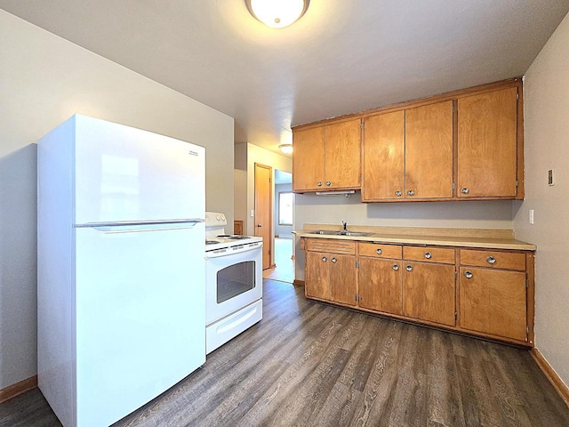 kitchen with white appliances, a sink, dark wood-type flooring, light countertops, and brown cabinets
