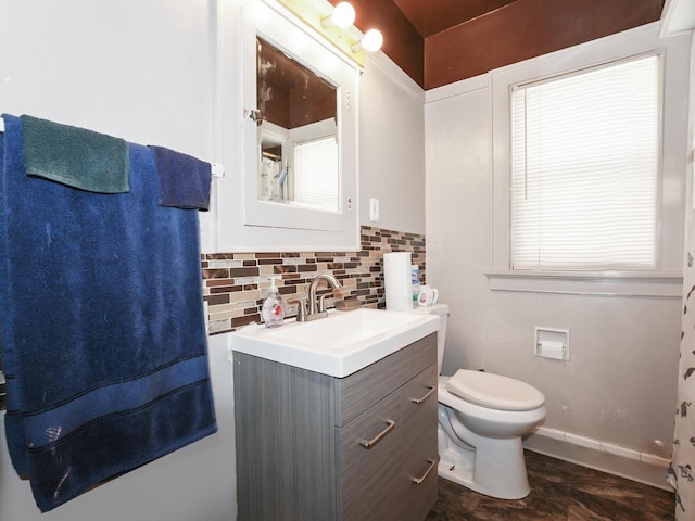 bathroom with toilet, tasteful backsplash, and vanity