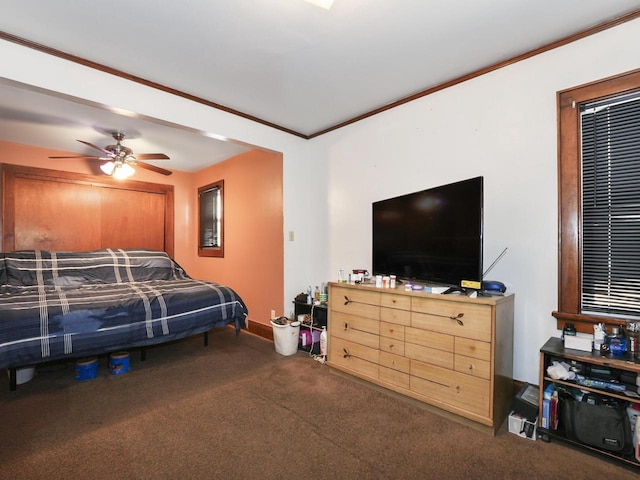 carpeted bedroom featuring crown molding and ceiling fan
