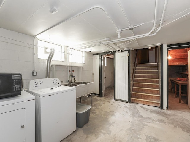 below grade area with washing machine and dryer, stairs, and a sink