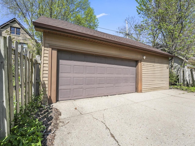 detached garage featuring fence