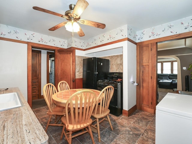 dining room featuring arched walkways and a ceiling fan
