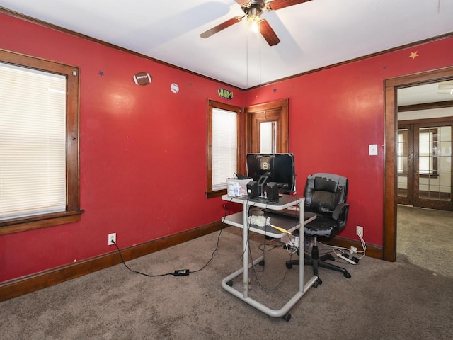 carpeted office with ceiling fan, baseboards, and crown molding