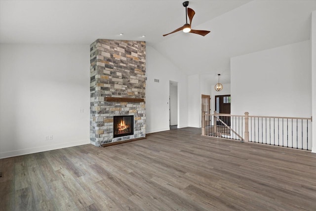 2161 Wallace Lake Rd Unit Lt10, West Bend, WI 53090 - unfurnished living room with a ceiling fan, high vaulted ceiling, wood finished floors, a stone fireplace, and baseboards